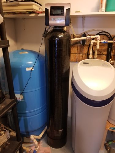 Water filter next to pressure tank