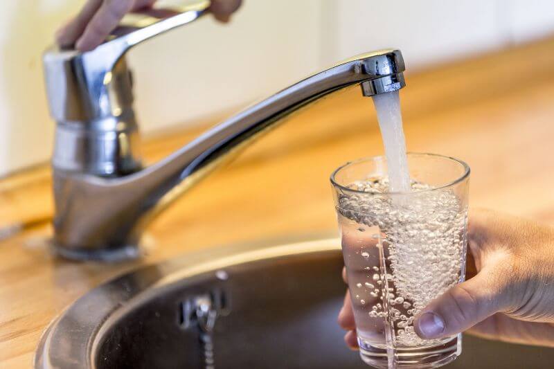 Filling a glass of water from a sink faucet