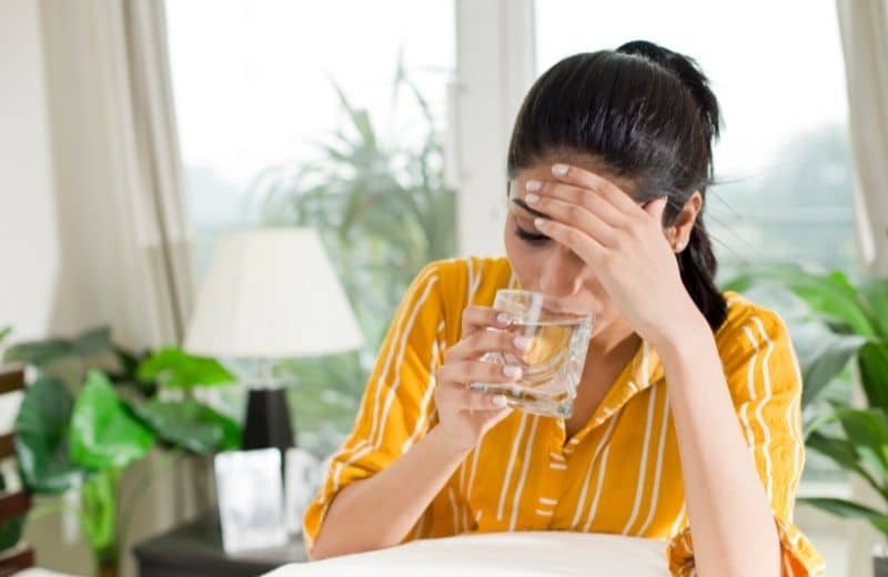 Woman feeling nausea after drinking water