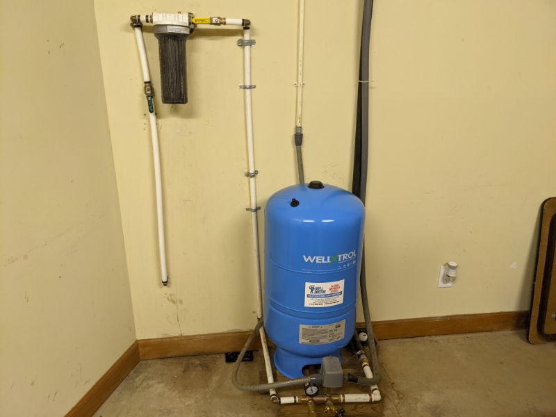 Air-over-water pressure tank in basement