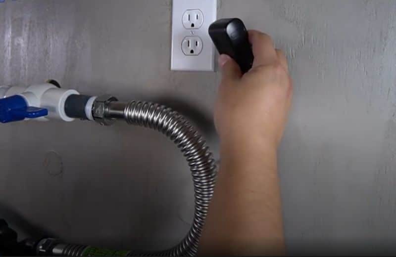 Plugging water softener into power outlet