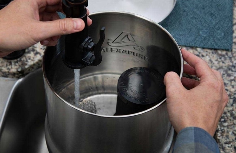 Pouring water to alexapure pro water filter