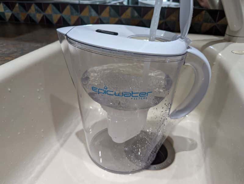 Filling the water filter pitcher with tap water