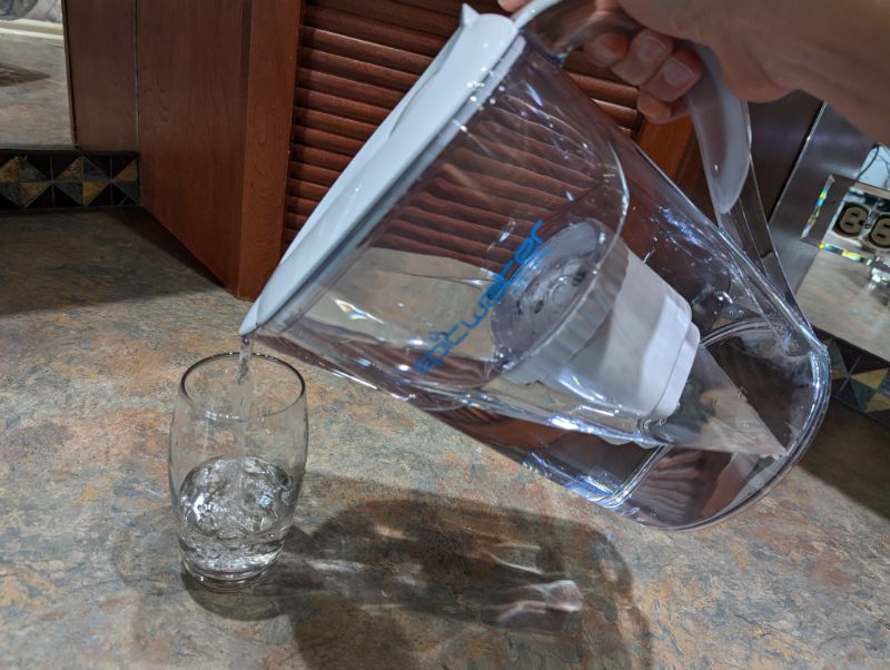 Pouring a glass of water from water filter pitcher