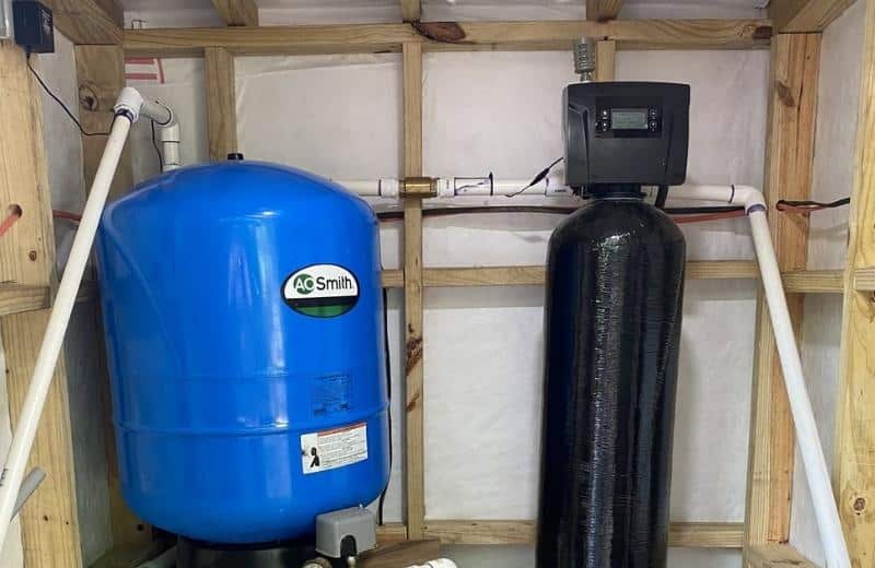 SoftPro ironmaster well water filter next to a pressure tank