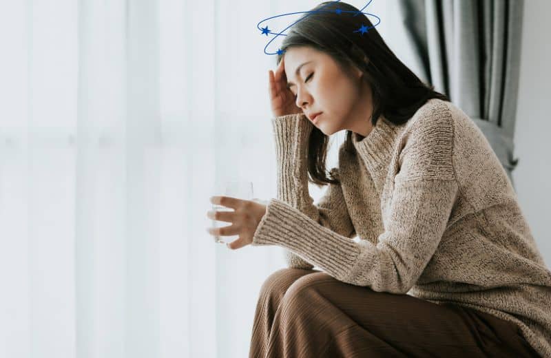 Woman feeling dizzy after drinking water