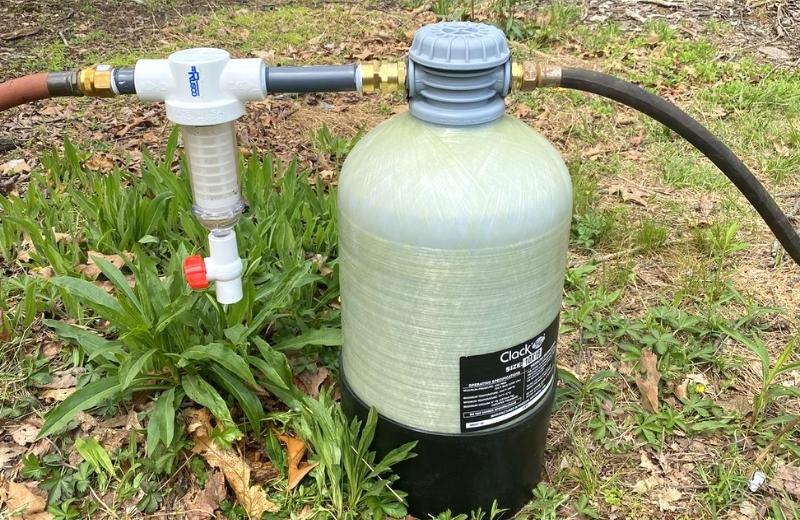 Portable water softener installed outdoor of a mobile home