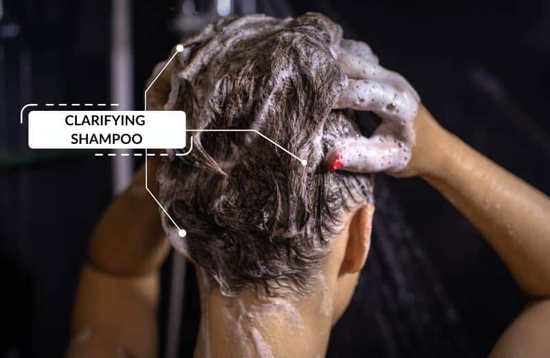 Woman washing hair with shower head filter