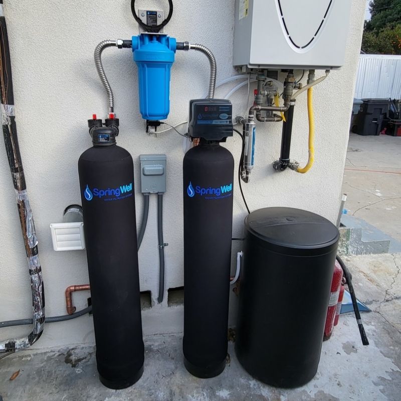 Water filtration and softening systems next to water heater