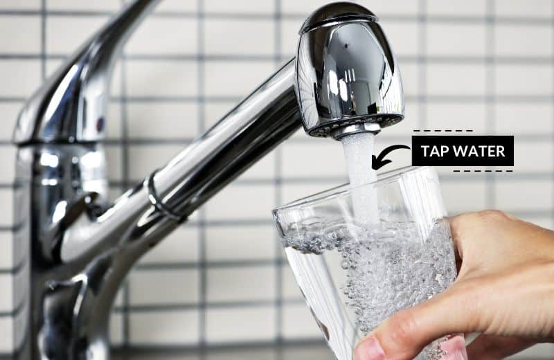 Filling glass of water from tap