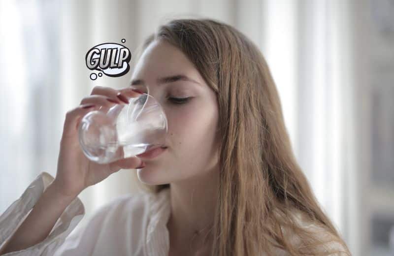 Woman drinking water that tastes like plastic