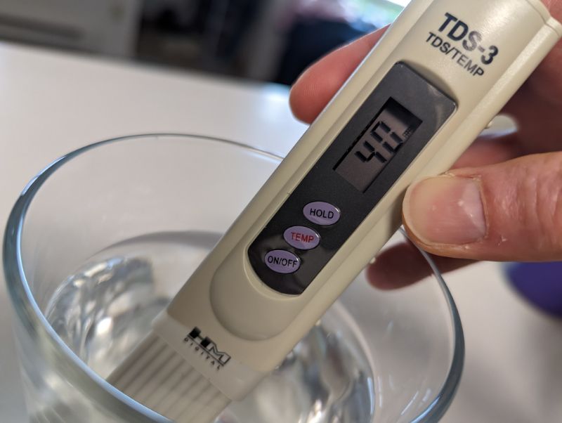 taking water tds reading with handheld tds meter