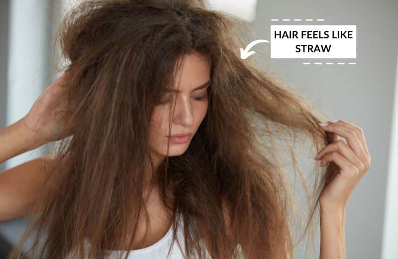 Woman wondering "why does my hair feel like straw?"