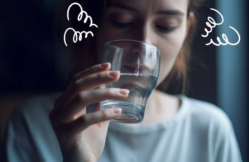 Woman with chronic kidney disease holding a glass of potassium softened water