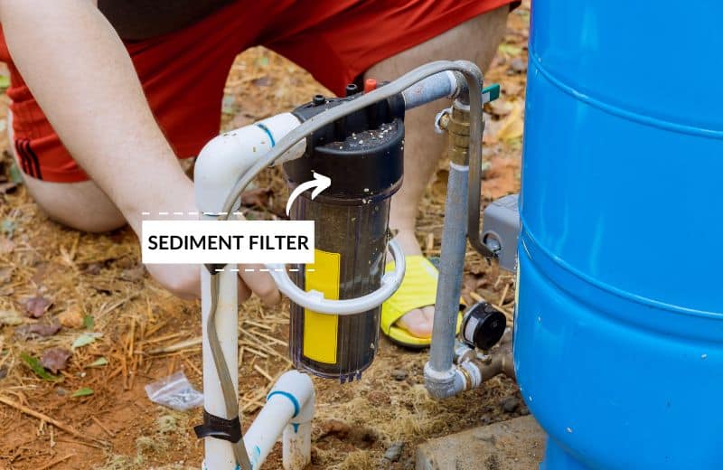 Sediment filter next to a well water tank