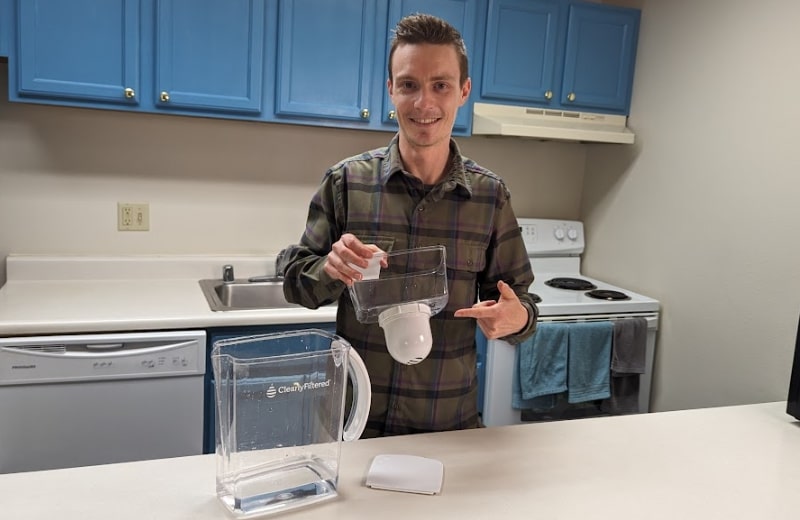 Brian holding the reservoir with attached filer cartridge of Clearly Filtered Pitcher