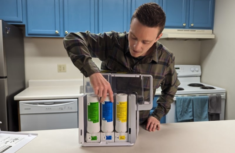 Brian installing the filter cartridges of AquaTru Countertop RO System