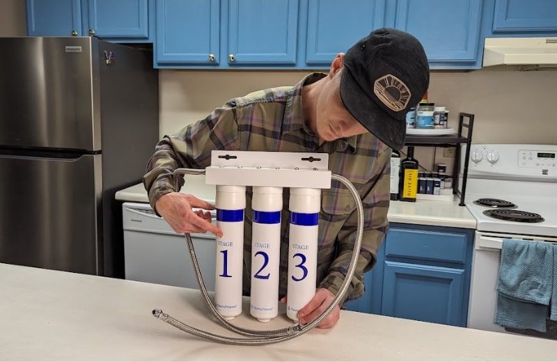 Brian pointing the filter stages of Clearly Filtered Under Sink System