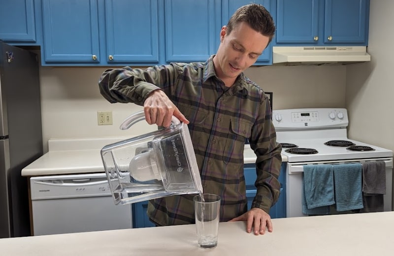 Brian pouring filtered water from Clearly Filtered Water Pitcher