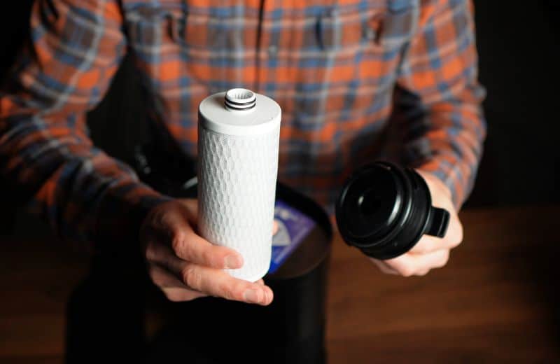Aquasana Clean Water Machine Filter Cartidge Brian holding the Aquasana Claryum filter cartridge