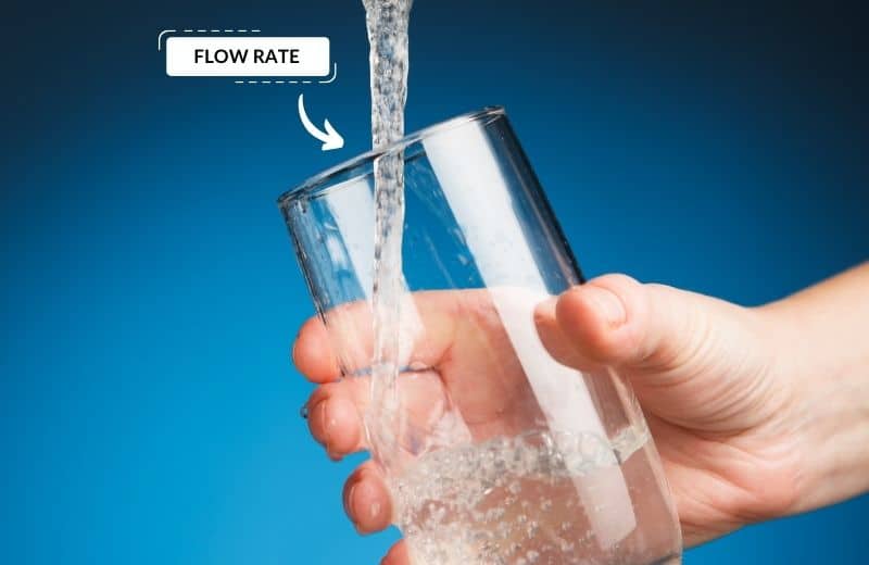 hand filling a glass of water from tap