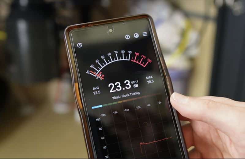 Brian holding his mobile phone showing noise level measurement