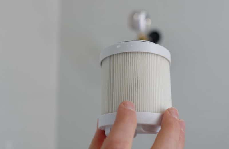 Filterbaby Filter Material Close-up of Filterbaby shower filter material, cartridge held in hand, showing pleated white micro-filter design