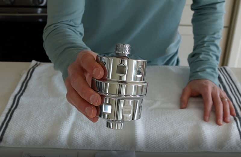 Hammerhead Shower Filter Design Hammerhead shower filter design featuring a polished chrome inline unit held by hand, showing durable metal housing and threaded connections for easy installation