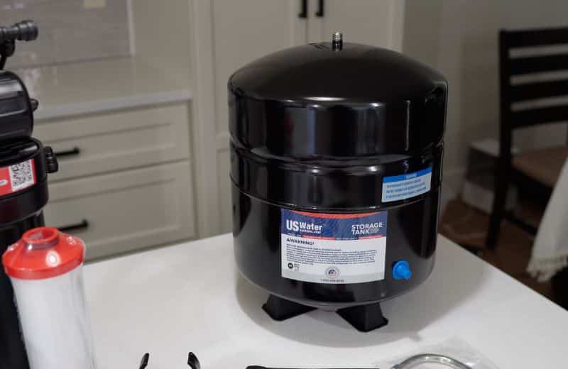 US Water Made RO pressurized storage tank US Water Made RO pressurized storage tank for reverse osmosis water filtration system displayed on a kitchen countertop during setup.